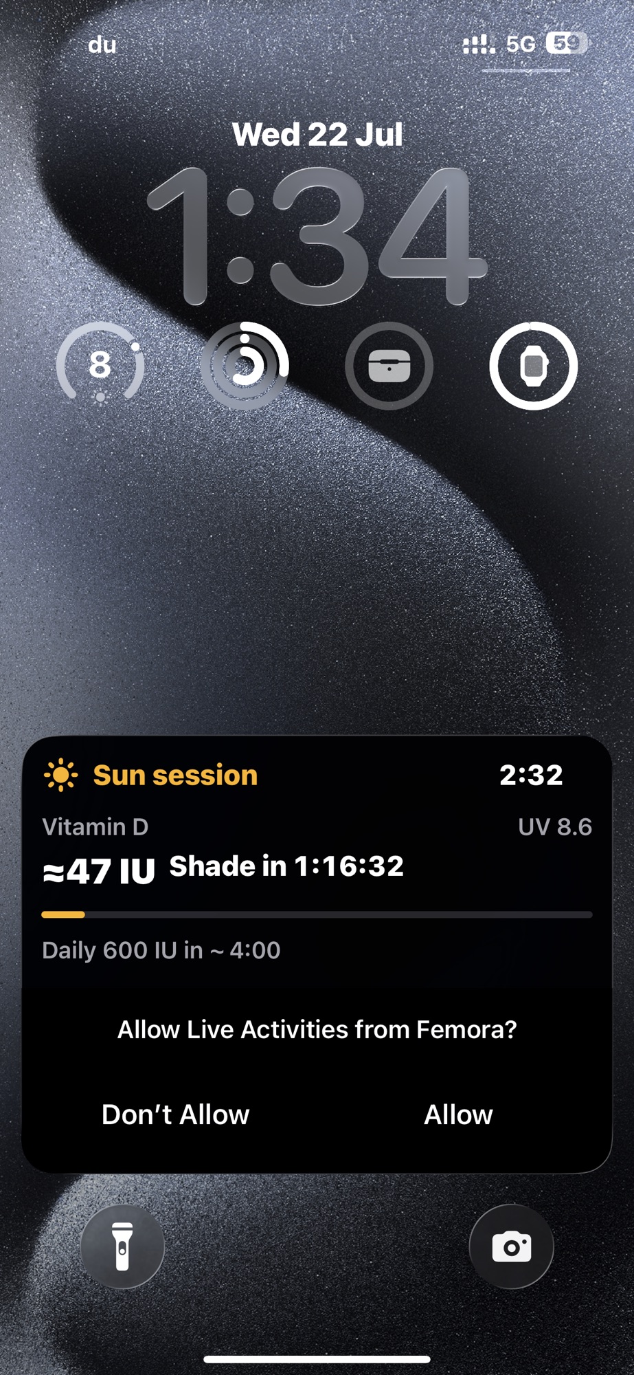 A Femora sun session as an iPhone lock screen Live Activity, showing vitamin D earned, the UV index, and a countdown to shade